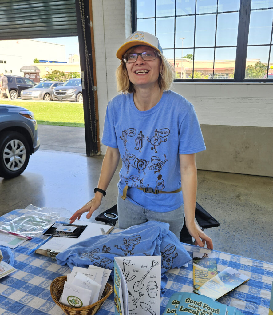 Emily Bidgood from Appalachian RCD Council greeting market attendees and telling them about the 2025 Farm Tour.