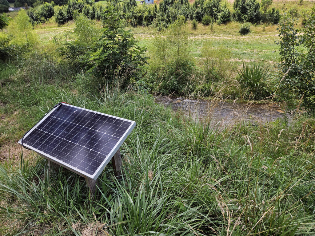 Solar powered pump brings irrigation water up from the creek.
