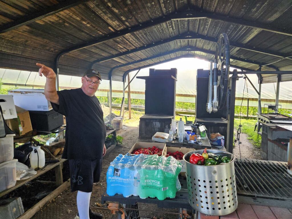 Matt stands in his outdoor kitchen explaining his philosophy and his family business