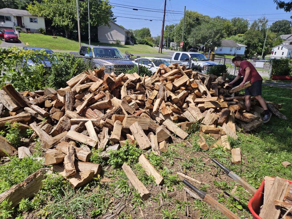 Keegan Anderson tends to the expansive wood pile at Bristol Gardens and Grill