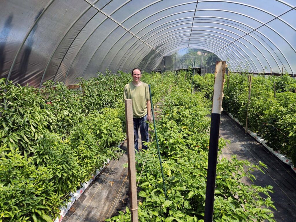 Addie Stinson stands soaking wet but proud of the pepper garden she takes care of