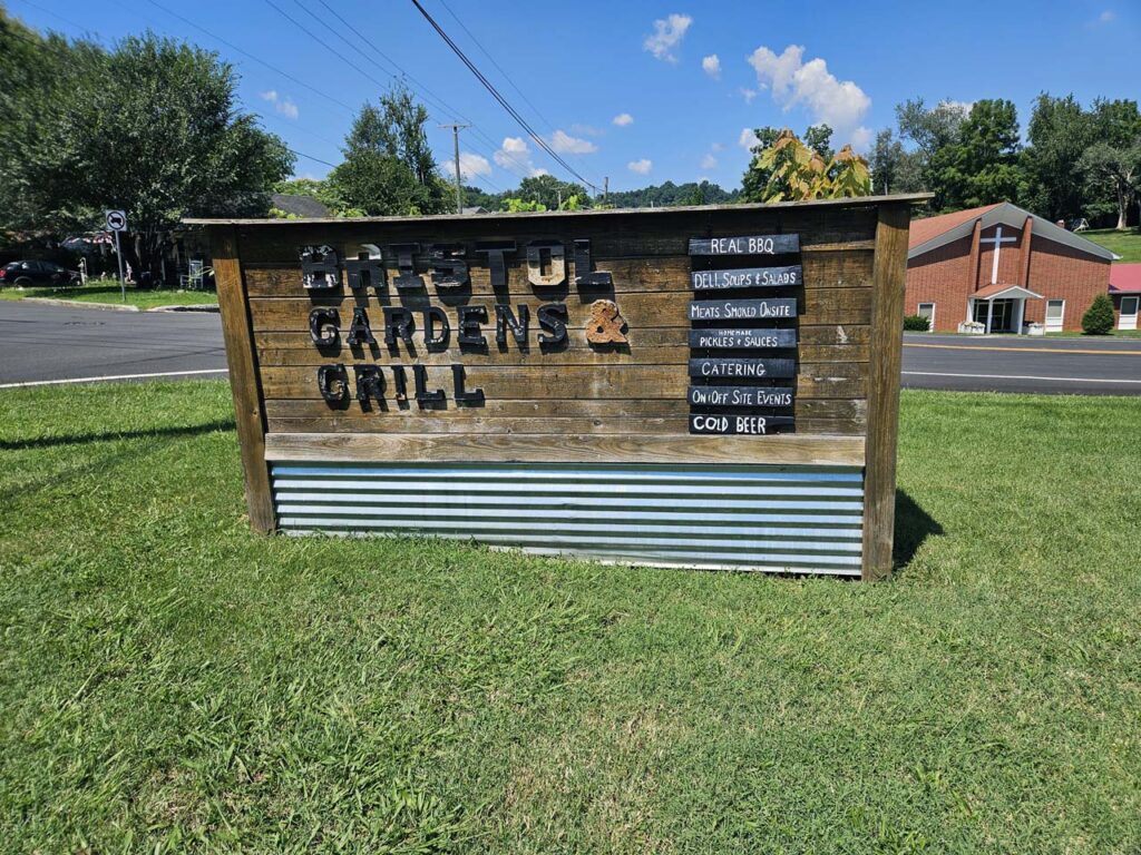 The rustic Sign at the entrance to Bristol Gardens & Grill