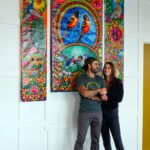 Mohsin and Katlin in front of custom art