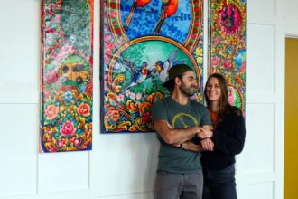 Mohsin and Katlin in front of custom art