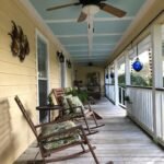 Porch with rocking chairs and a Haint Blue Ceiling Photo by Jose-Cruz