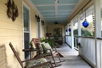 Porch with rocking chairs and a Haint Blue Ceiling Photo by Jose-Cruz
