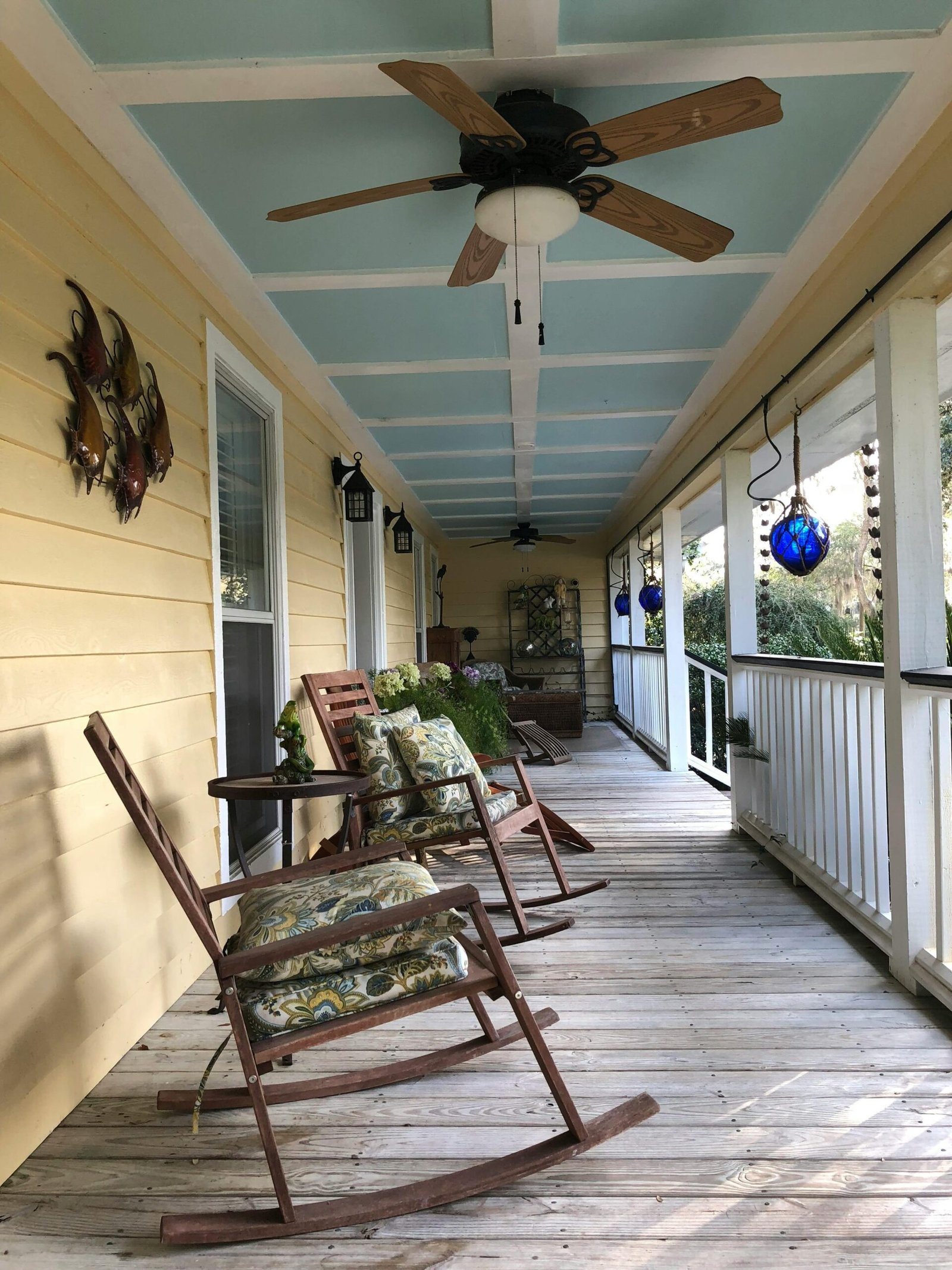 Porch with rocking chairs and a Haint Blue Ceiling Photo by Jose-Cruz