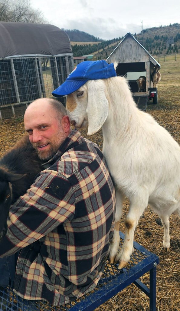 Eric playing with goats