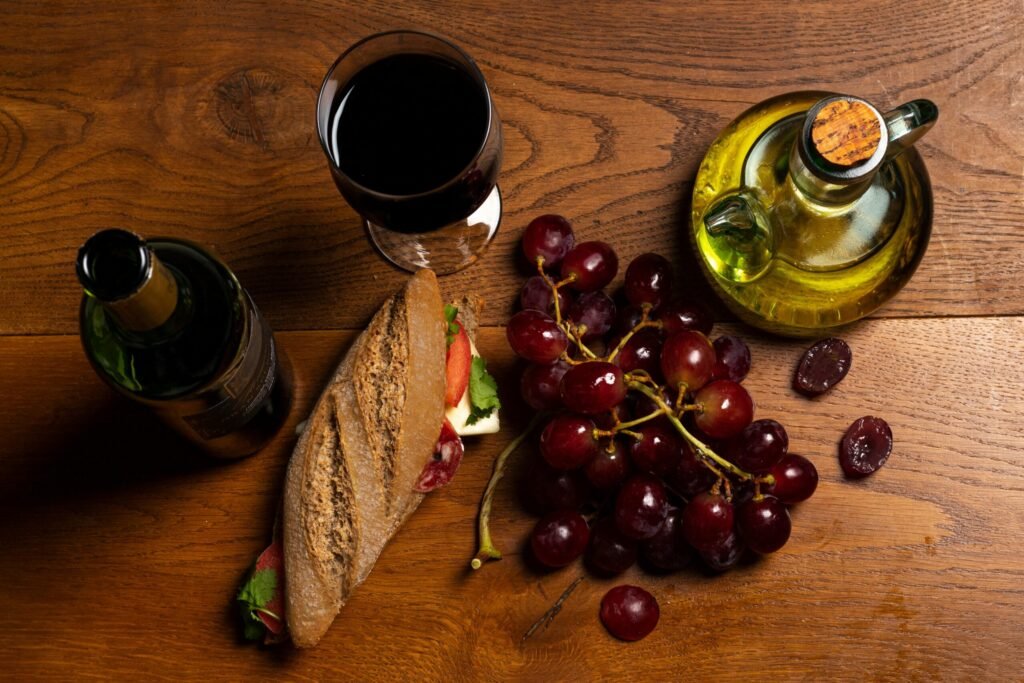 Still life with wine, garpes, bread, and oil