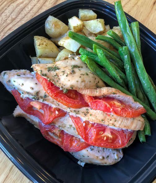 Balsamic Roasted Springer Mountain Farms chicken stuffed with tomatoes and Ziegenwald Dairy goat cheese. Served at the Boone Street Market