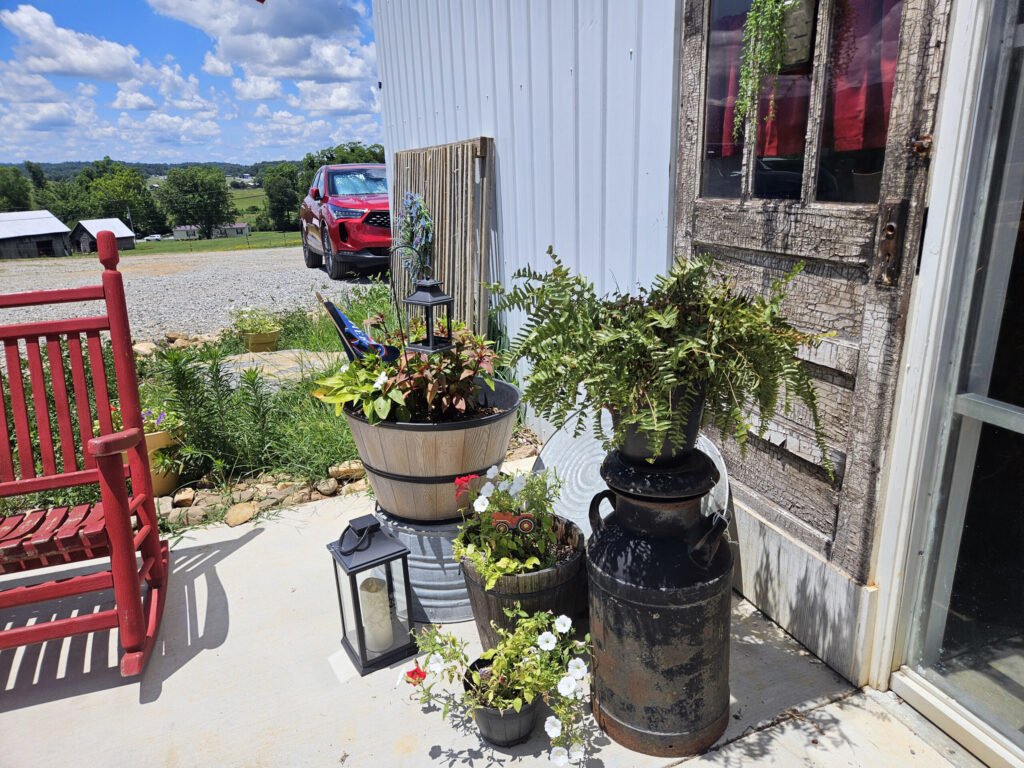 Red rocker, a converted barrel, a converted Milk Can all made into decorative pieces at Little Lou's Creamery.