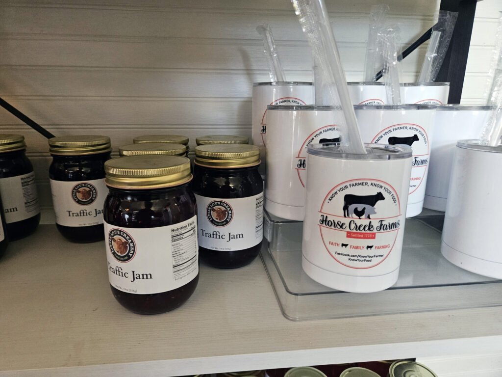 An assortment of Jams, Jellies and custom Ice Cream cups with the Little Lou's Creamery Logo