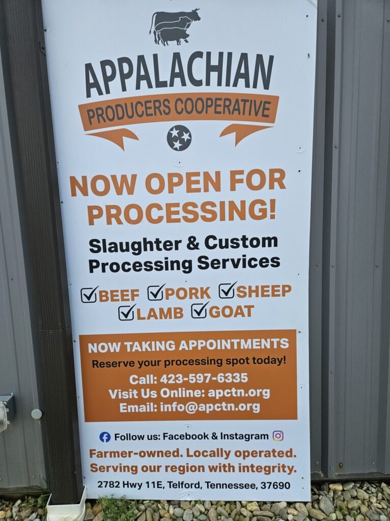 20260613_142413 - Appalachian Highlands Farmers Magazine Sign for Appalachian Producers Cooperative announcing'Now Open for Processing' with beef, pork, sheep, goat processing services and contact info (Telford, TN).