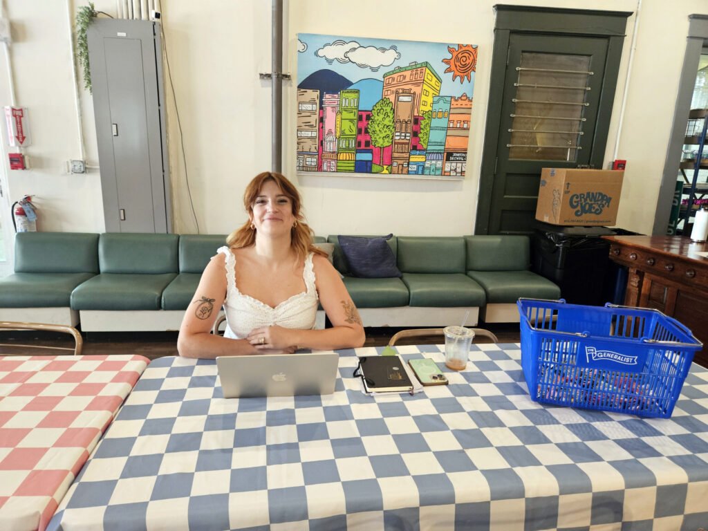 Lora sits at the table in the event space inside the Generalist.