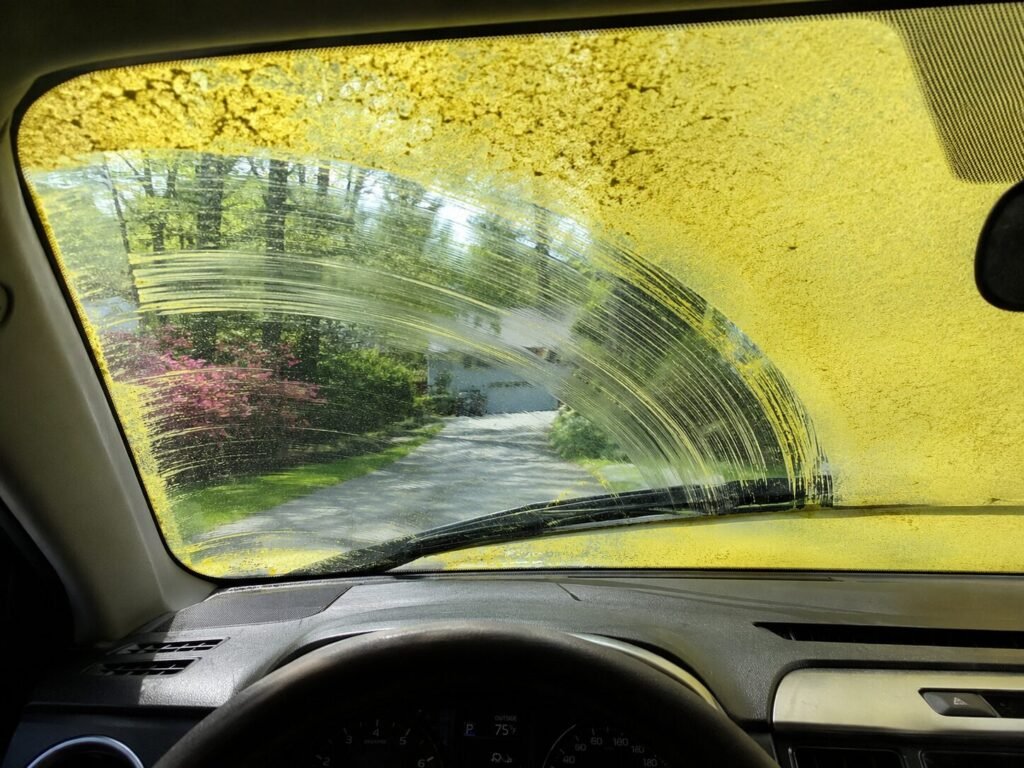A windshield covered with pollen.