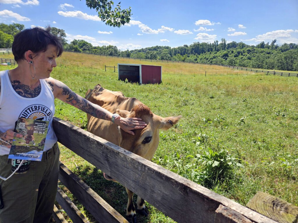 Abby Terhune pets Bessie the cow.
