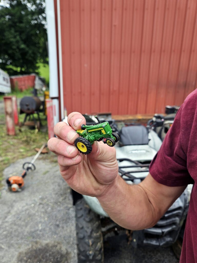 Jackson holding a little tactor that goes in the Donaldson pre-cleaner