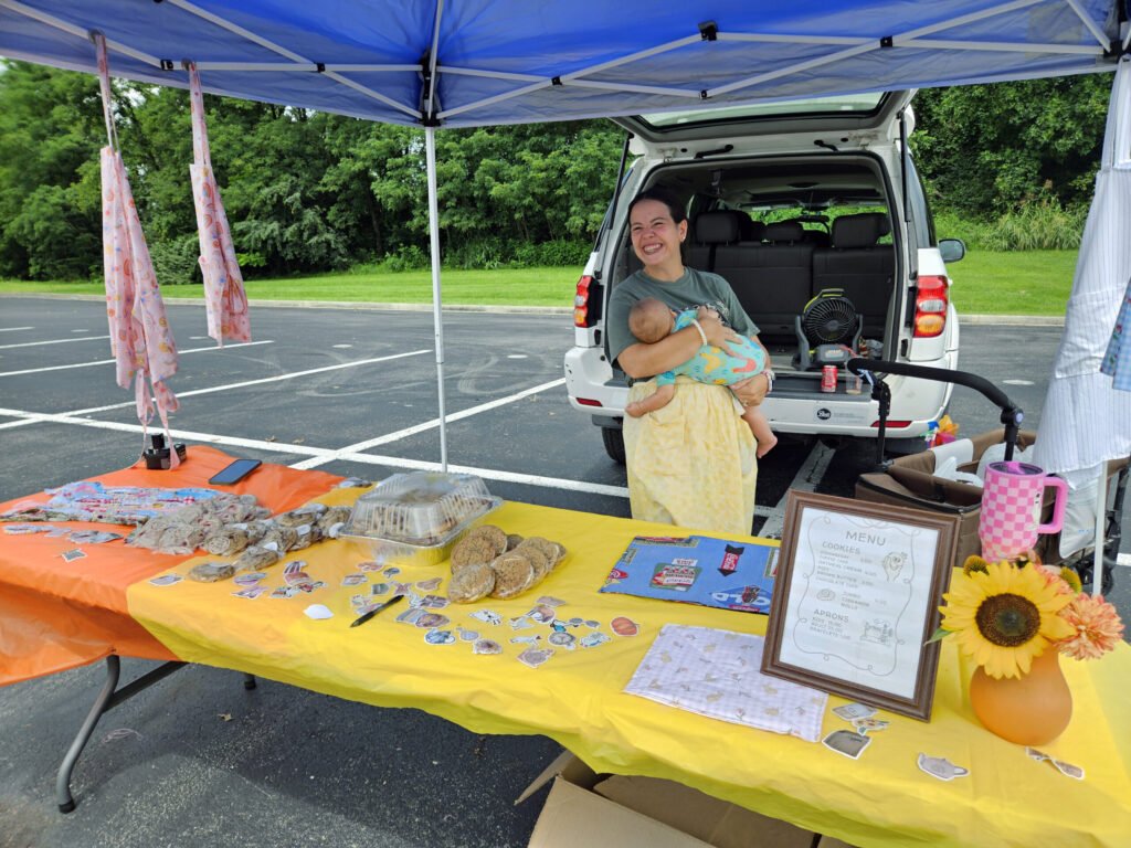 Baked with Love Bakery selling treats, cookies, and aprons