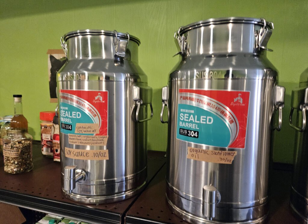 Bulk cans with Coconut Aminos and Bragg Aminos