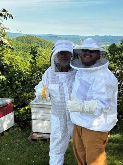 Jim Lyttle and Travis Brookes tending to the bees.