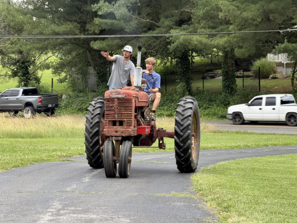 Jackson Fleenor guides his cousin while riding on the M series