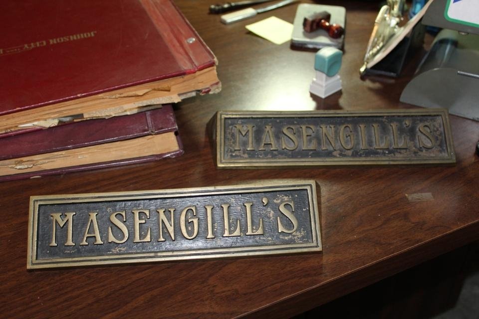 A picture of two bronze plaques that say Massengill's