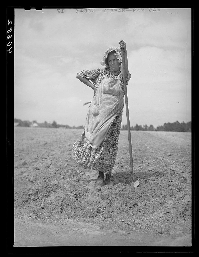 This woman and her daughter are helping their neighbors plant their tobacco field. The bonnet is homemade. On U.S. 15, about five miles northeast of Durham, North Carolina 1940 May - Delano, Jack, 1914-1997