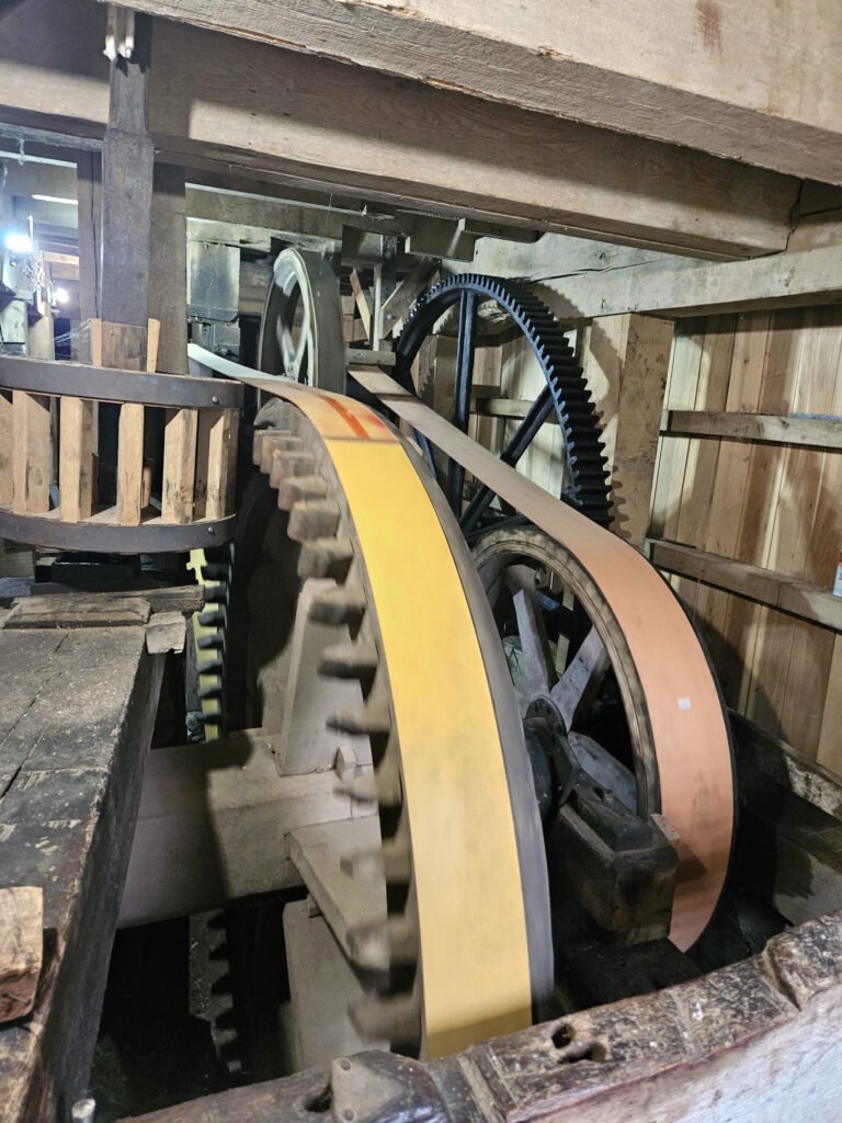 The gear wheels in the basement that connect to the waterwheel on the outside, These gears drive everything in the mill.