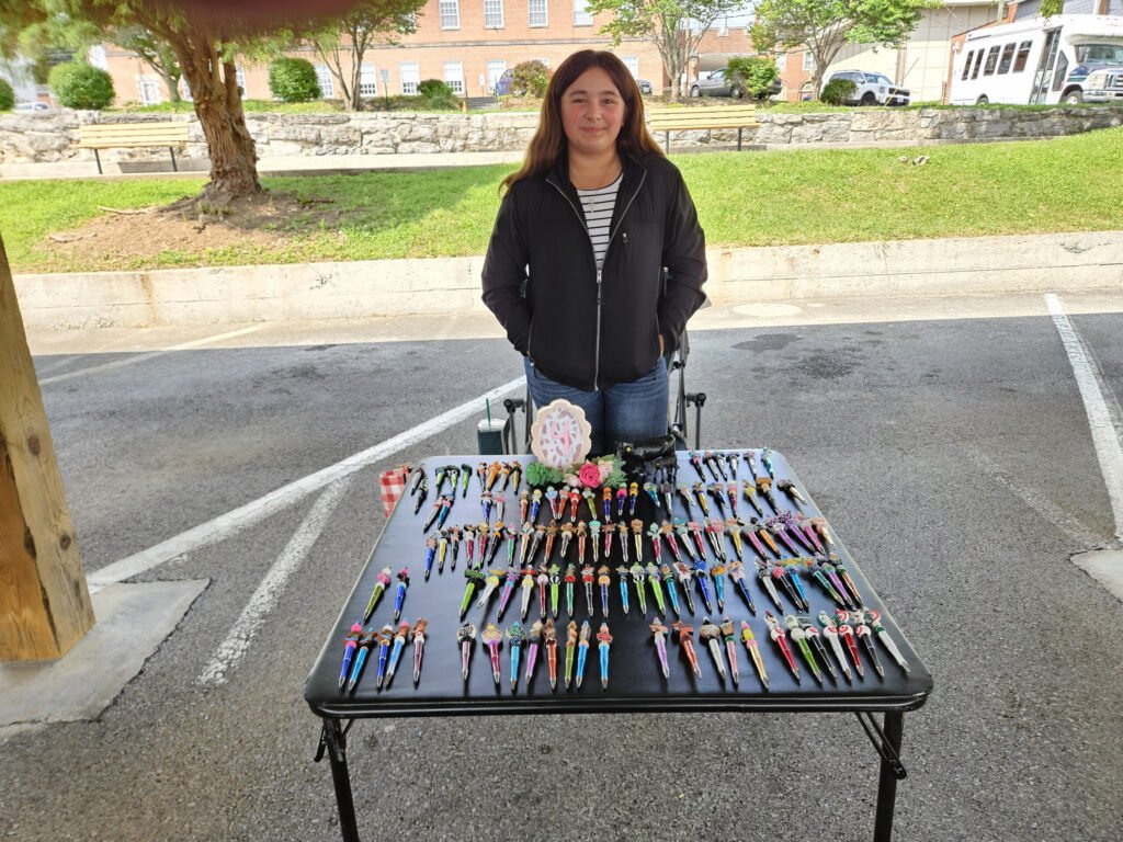 Charlotte and her handmade pens at the Marion Farmers Market