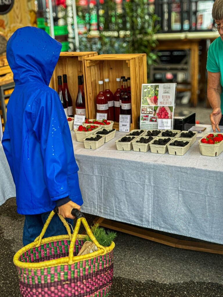 yzy-pop-whv0X1xCA4o-unsplash - Appalachian Highlands Farmers Magazine Boy looks at a farmers market table