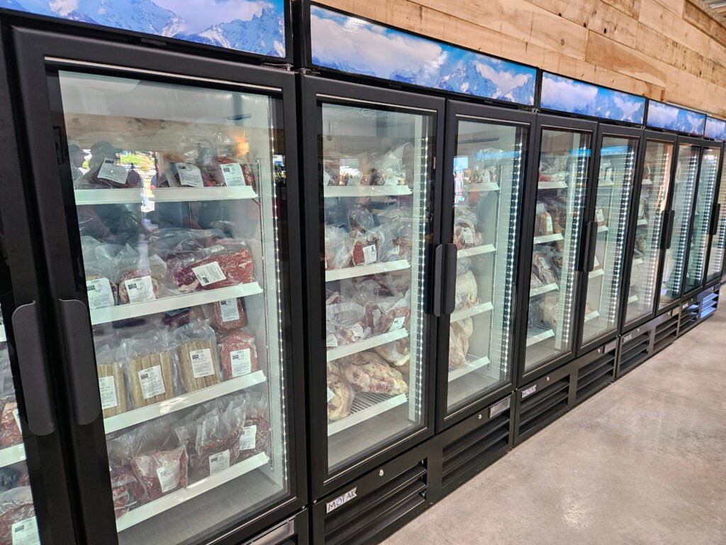 20260926_123950 - Appalachian Highlands Farmers Magazine A long line of freezers stocked with meat at Lewis' Country Store