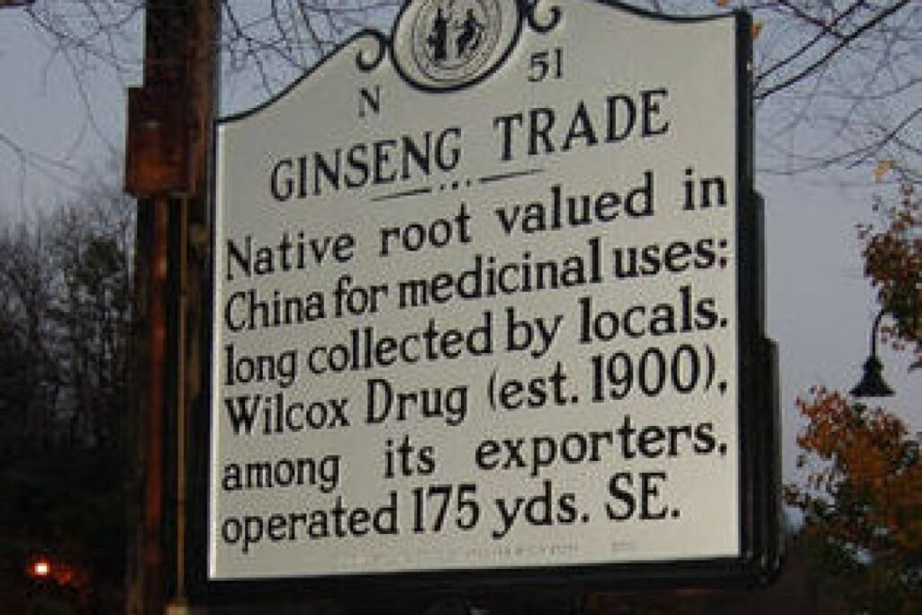 N-51a - Appalachian Highlands Farmers Magazine Informational roadside sign about the ginseng trade:'Native root valued in China for medicinal uses; long collected by locals' with 'Wilcox Drug (est. 1900)'.